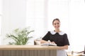 Chambermaid near reception in hotel. Space for text Royalty Free Stock Photo