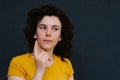 Young charismatic caucasian woman showing finger up on the grey background.