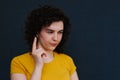 Young charismatic caucasian woman showing finger up on the grey background.