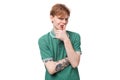 young charming adorable ginger man with a tattoo on his arm dressed in a green short sleeve t-shirt against the Royalty Free Stock Photo