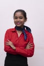 Young charming air hostess in red dress with blue collar posing in front of the camera with white background and copy space Royalty Free Stock Photo