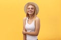 Young charming blond woman with happy exited emotional face looking at camera, over yellow background Royalty Free Stock Photo