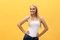 Young charming blond woman with happy exited emotional face looking at camera, over yellow background Royalty Free Stock Photo