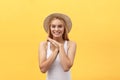 Young charming blond woman with happy exited emotional face looking at camera, over yellow background Royalty Free Stock Photo