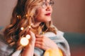 Young charming blonde woman in glasses with lights in her hair, romantic atmospheric photo about dreams, blurred focus Royalty Free Stock Photo