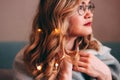 Young charming blonde woman in glasses with lights in her hair, romantic atmospheric photo about dreams Royalty Free Stock Photo