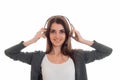 Young charming brunette business woman with headphones and microphone looking at the camera and smiling isolated on Royalty Free Stock Photo