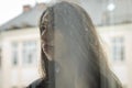 Young charming brunette girl behind a glass window Royalty Free Stock Photo