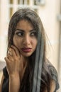 Young charming brunette girl behind a glass window Royalty Free Stock Photo