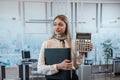 Young charming caucasian woman in suit hold calculator in business cetner