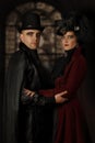 Portrait of a young charming couple dressed in old fashioned clothes in the vampire style