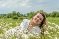 Young charming girl in a camomile field Royalty Free Stock Photo