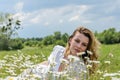 Young charming girl in a camomile field Royalty Free Stock Photo