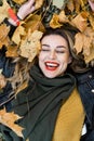 Young charming girl with curled long blonde hair and red lipstick on her lips is enjoying autumn Royalty Free Stock Photo