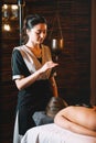 Young charming girl on a panchakarma procedure laying on a massage table. beautiful woman spending time at modern spa