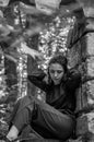 Young charming girl the teenager with long hair sitting on the sad ruins of an ancient stone castle window in Striysky Park in Lvi Royalty Free Stock Photo