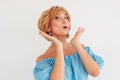 Young charming surprised blonde short hair woman in blue summer dress, isolated on white background Royalty Free Stock Photo