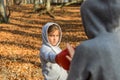 Young charming woman boxing trainer in a tracksuit with a hood on her head, trains a little child girl in red boxing mittens at bo Royalty Free Stock Photo