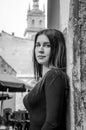 Young charming woman with long curly hair, strolling among the old town of Lviv architecture in black dress Royalty Free Stock Photo