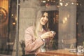 Young charming woman spend time while sitting in coffee shop during free time, attractive female with cute smile having talking