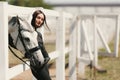 Young charming woman walking with white horse in summer warm day at country estate. Lifestyle mood. Concept of nature Royalty Free Stock Photo