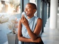 Young cheerful African american businesswoman removing her mask while at work. One happy black female businessperson