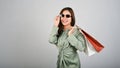 Young cheerful Asian woman holding shopping bags in her hand with white isolated background Royalty Free Stock Photo