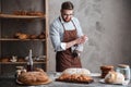 Young cheerful bearded man wearing glasses baker Royalty Free Stock Photo