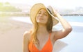 Young cheerful bikini woman with hat enjoying sun on tropical beach. Relaxing sunbathing holidays in Tenerife Royalty Free Stock Photo