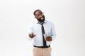 Young cheerful black businessman holding and pointing at money isolated on white