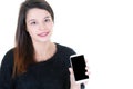 Young cheerful brunette woman holding out blank black screen smartphone phone in her hand Royalty Free Stock Photo