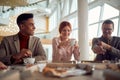 A young cheerful business woman enjoys coffee with her male colleagues after a lunch break in the company building. Business, Royalty Free Stock Photo