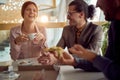 A young cheerful business woman is having a good time with her male colleagues during a lunch break in the company building. Royalty Free Stock Photo