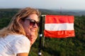 Young cheerful Caucasian woman relaxing in nature at Austrian flag Royalty Free Stock Photo