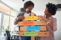 Young cheerful colleagues are enjoying to promote company slogans and posing for a photo in the office. Employees, job, office Royalty Free Stock Photo