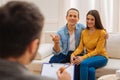 Young cheerful couple consulting with psychologist