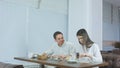 Young cheerful couple enjoying business lunch at restaurant Royalty Free Stock Photo