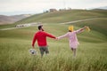 A young cheerful couple having a good time while walking a large meadow. Love, relationship, together, nature Royalty Free Stock Photo