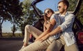 Young Cheerful Couple Hugging in Car Trunk Royalty Free Stock Photo