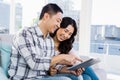 Young cheerful couple looking at digital tablet Royalty Free Stock Photo