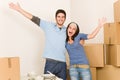 Young cheerful couple moving into new home