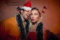 A young cheerful couple posing for a photo at New Year eve home party. Friendship, together, party, New Year