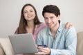 Young cheerful couple shopping online via laptop with credit ca Royalty Free Stock Photo