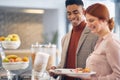 Young cheerful employees picking up a food at company canteen. People, job, company, business concept Royalty Free Stock Photo