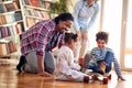 A young cheerful family having a fun while playing at home together. Family, together, love, playtime Royalty Free Stock Photo