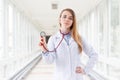 Young cheerful female doctor portrait with a stethoscope in clinic Royalty Free Stock Photo