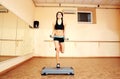 Young cheerful fit woman doing exercises with dumbells on step board Royalty Free Stock Photo