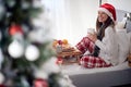 A young cheerful girl in the bed has wonderful Xmas morning. Christmas, relationship, love, together