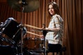 Young cheerful girl behind drums on a rehearsal Royalty Free Stock Photo