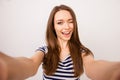 Young cheerful girl in striped t-shirt taking selfie and winking Royalty Free Stock Photo